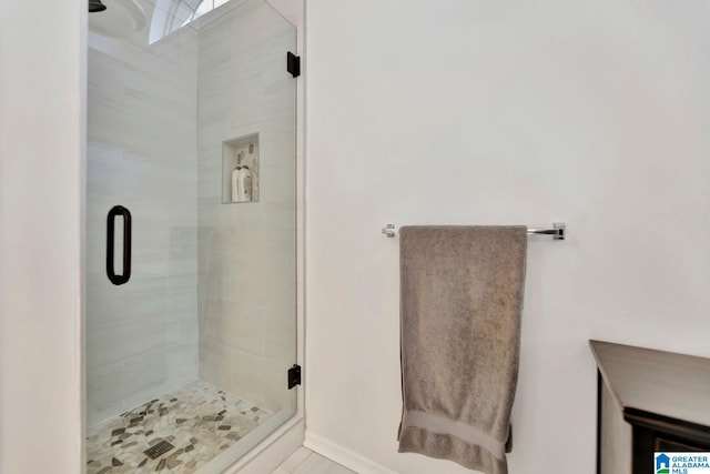 bathroom featuring an enclosed shower and tile patterned floors