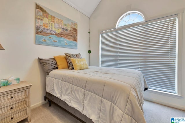 carpeted bedroom with lofted ceiling