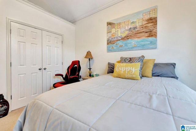 bedroom with carpet flooring, a closet, and ornamental molding