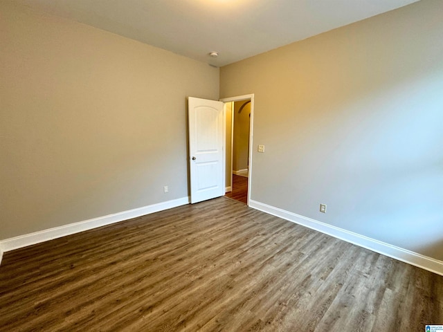 empty room with hardwood / wood-style flooring