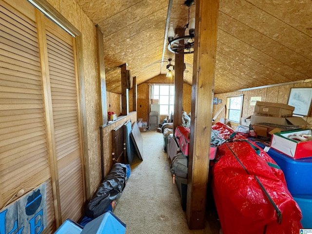 interior space with wood walls, carpet, wood ceiling, and vaulted ceiling