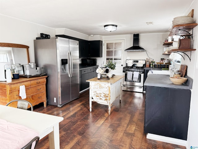 kitchen featuring sink, wall chimney range hood, dark hardwood / wood-style flooring, a kitchen island, and appliances with stainless steel finishes