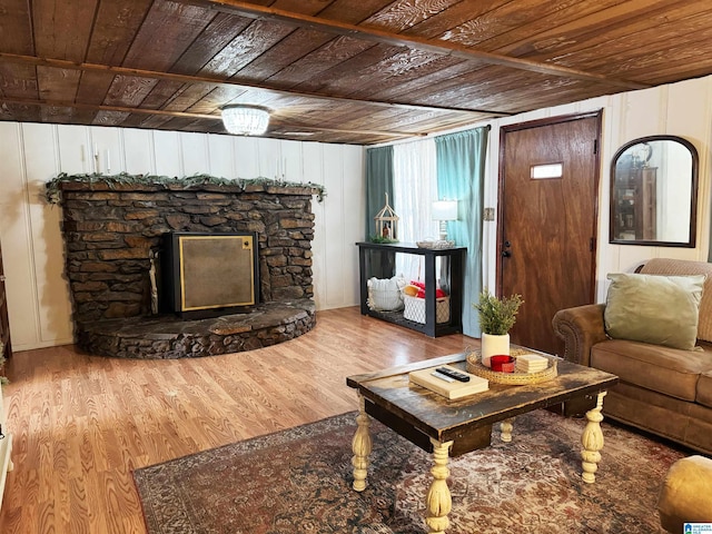 living room featuring a fireplace, hardwood / wood-style floors, and wood ceiling