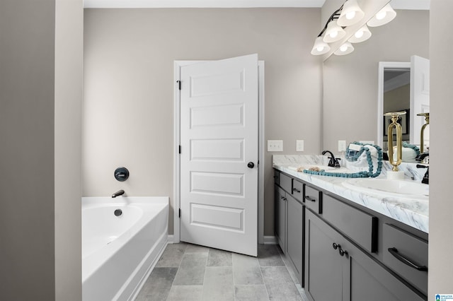 bathroom featuring tile patterned floors, a washtub, and vanity