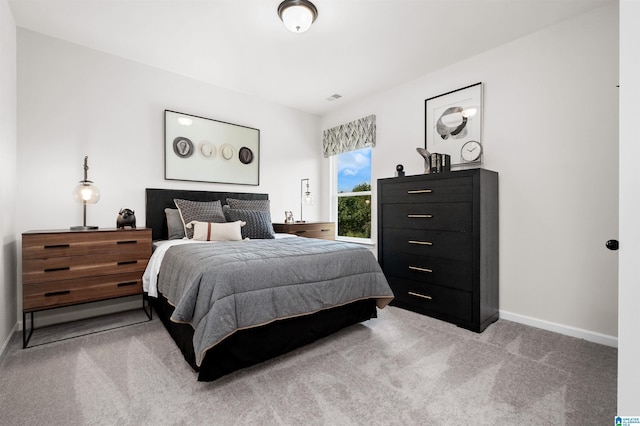 bedroom featuring light carpet