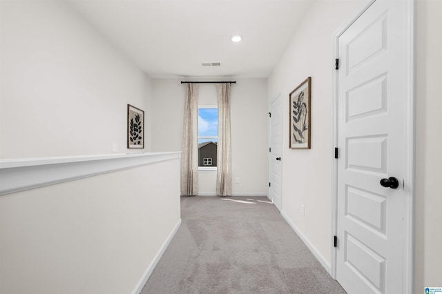 hallway featuring light carpet