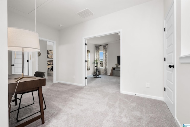 hallway featuring light colored carpet