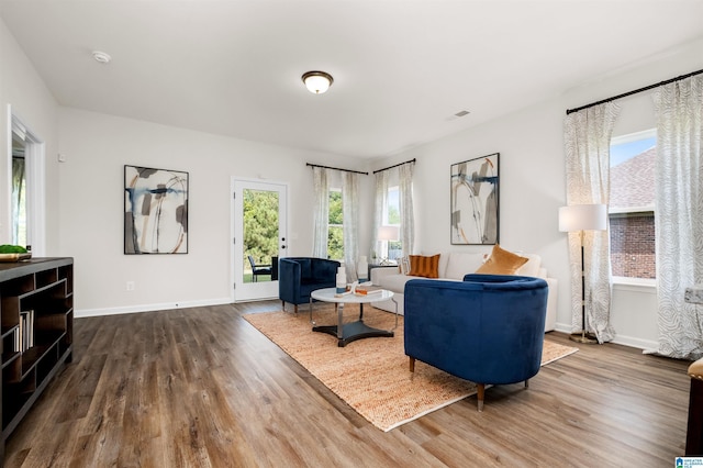 living room with a wealth of natural light and dark hardwood / wood-style floors