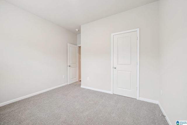 empty room with light colored carpet