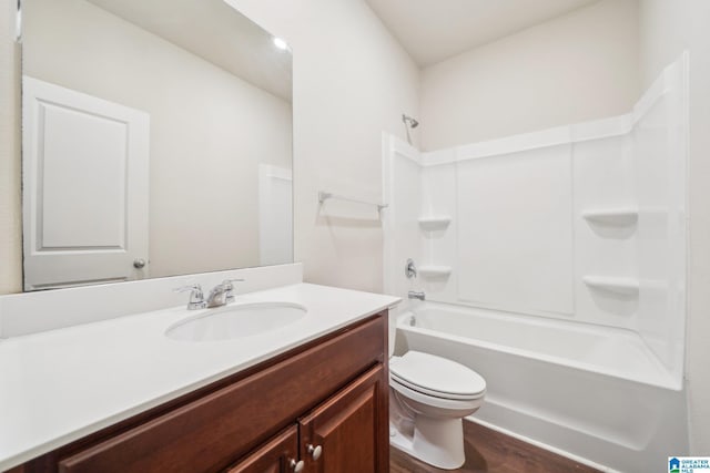 full bathroom with vanity, shower / bath combination, toilet, and hardwood / wood-style flooring