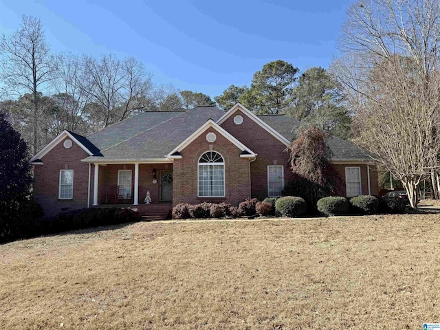 view of front of home with a porch and a front yard