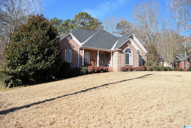 view of front of property with a front yard and a porch