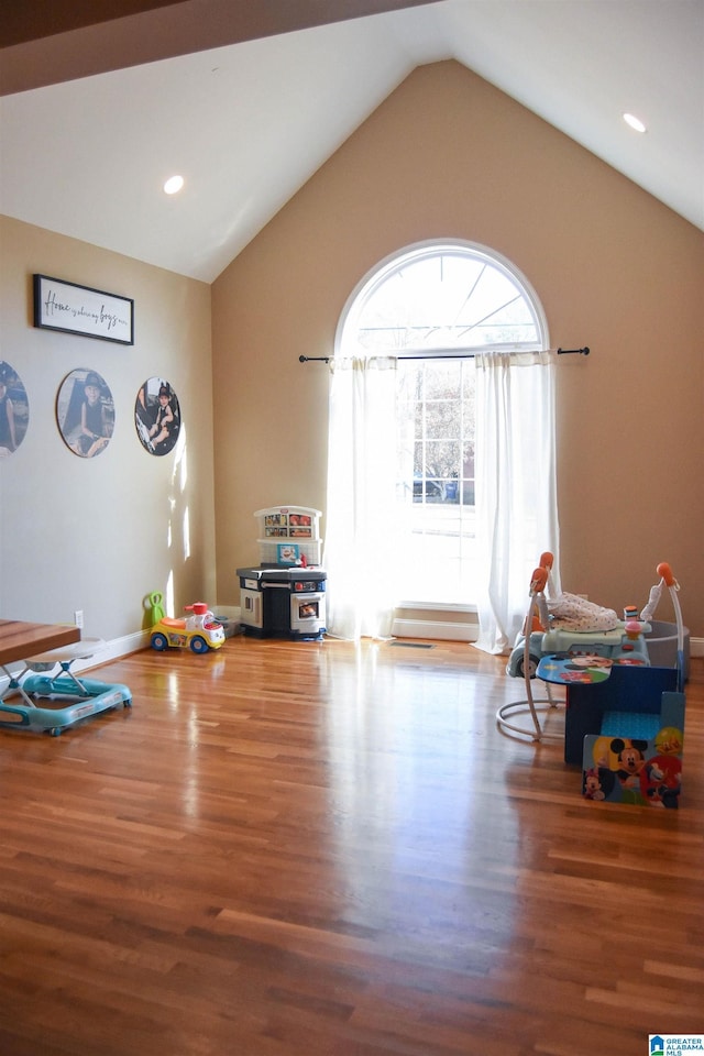 misc room featuring hardwood / wood-style floors and vaulted ceiling