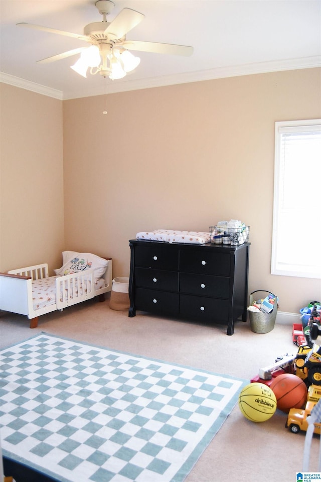 carpeted bedroom with crown molding and ceiling fan