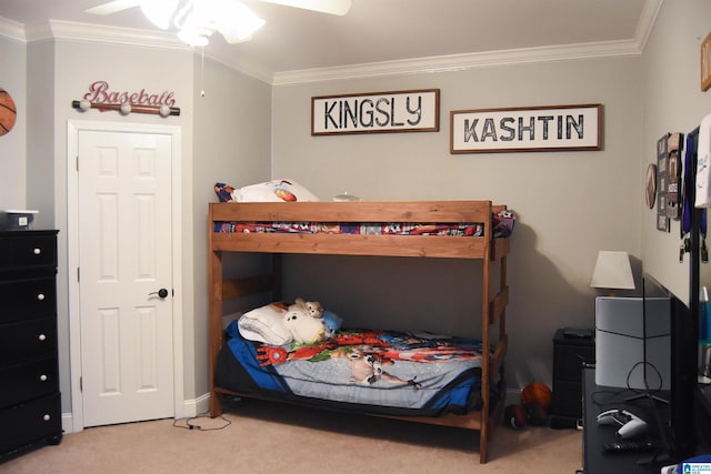 carpeted bedroom featuring ceiling fan and ornamental molding