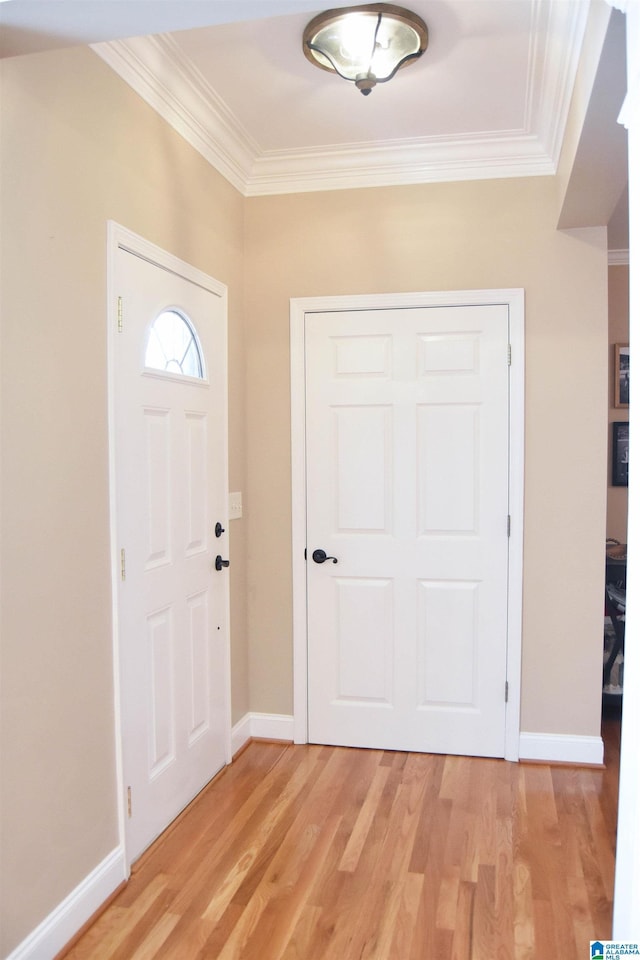 foyer with light hardwood / wood-style flooring and ornamental molding