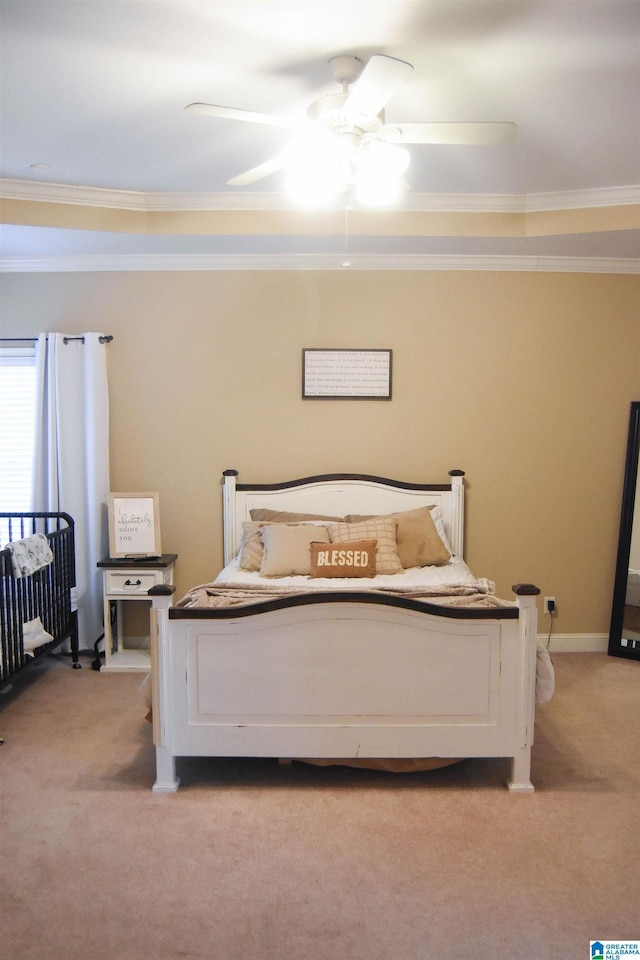 carpeted bedroom with ceiling fan and ornamental molding