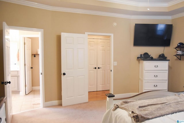 carpeted bedroom featuring crown molding and a closet