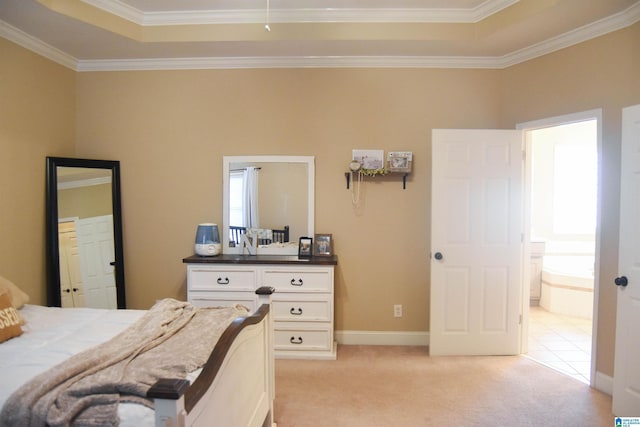 carpeted bedroom featuring connected bathroom, a raised ceiling, and ornamental molding