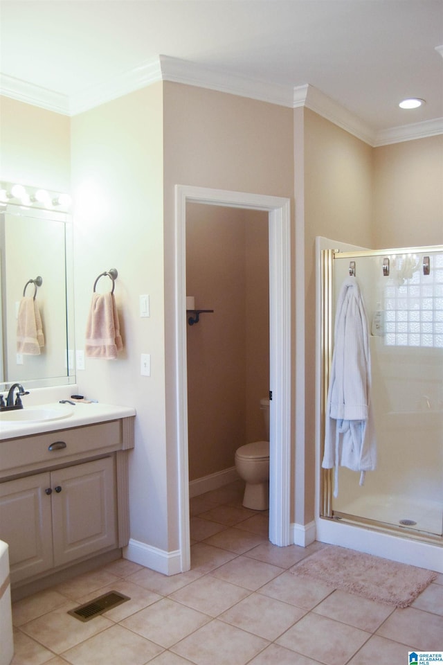 bathroom with toilet, tile patterned flooring, vanity, and ornamental molding