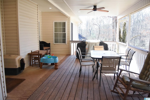 deck featuring area for grilling and ceiling fan