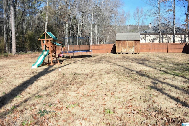 view of yard with a playground, a trampoline, and a shed