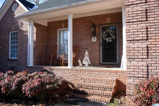 view of exterior entry with a porch