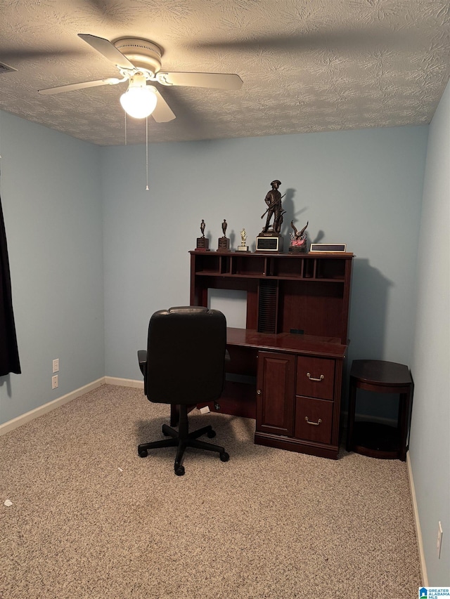 office area with ceiling fan, light colored carpet, and a textured ceiling