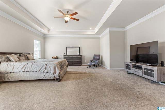 bedroom with ceiling fan, carpet floors, crown molding, and a tray ceiling