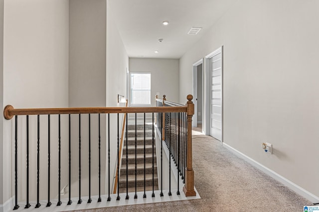 hall featuring carpet flooring