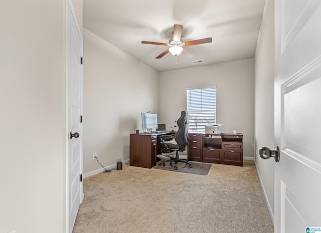 carpeted home office featuring ceiling fan