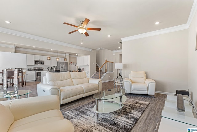 living room with crown molding, ceiling fan, and dark wood-type flooring