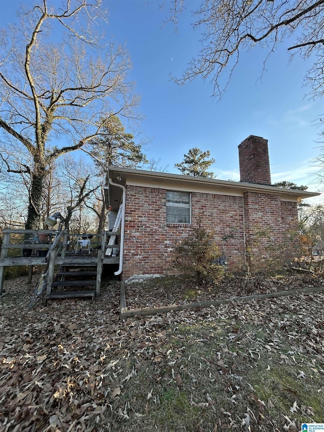 view of side of home with a deck