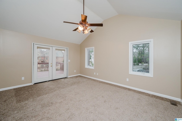 empty room with ceiling fan, french doors, carpet, and vaulted ceiling