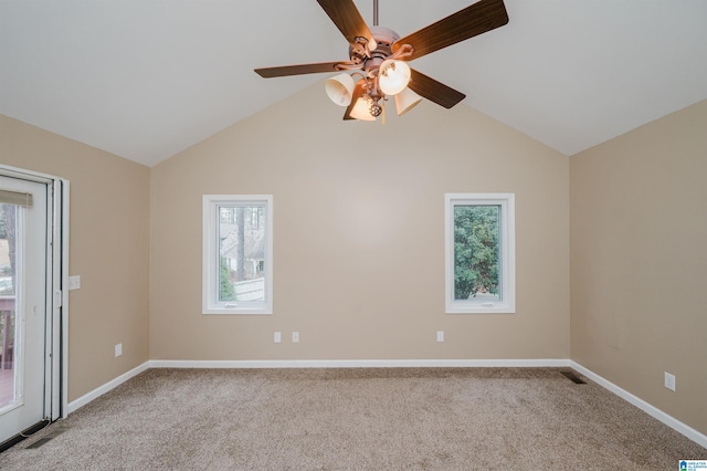 carpeted spare room with ceiling fan and vaulted ceiling