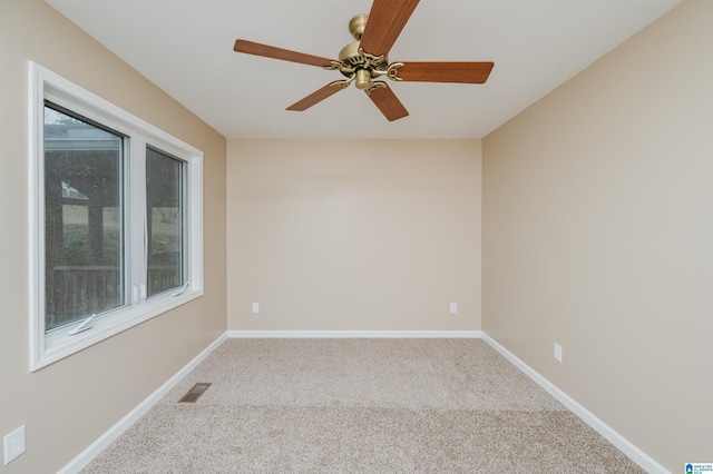 carpeted empty room featuring ceiling fan and a healthy amount of sunlight