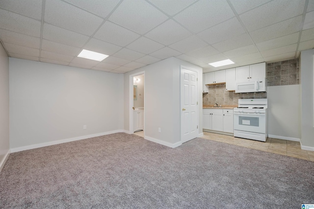 kitchen featuring white cabinets, white appliances, tasteful backsplash, and a drop ceiling