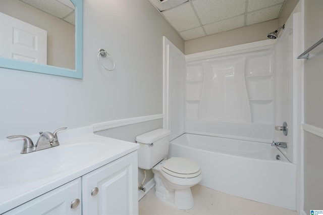 full bathroom featuring tile patterned flooring, toilet, a paneled ceiling, vanity, and shower / bathtub combination