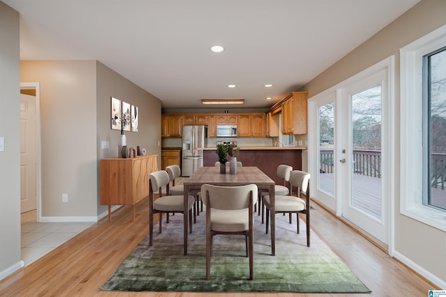 dining area featuring french doors and light hardwood / wood-style flooring