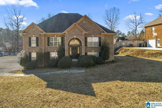 view of front of home with a garage and a front lawn