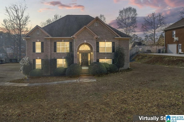 view of front of property featuring a lawn and a garage