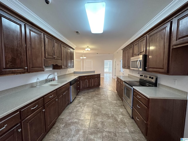 kitchen with dark brown cabinetry, sink, and appliances with stainless steel finishes