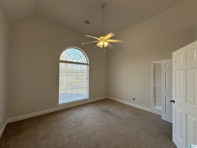 unfurnished room with dark colored carpet, ceiling fan, and lofted ceiling