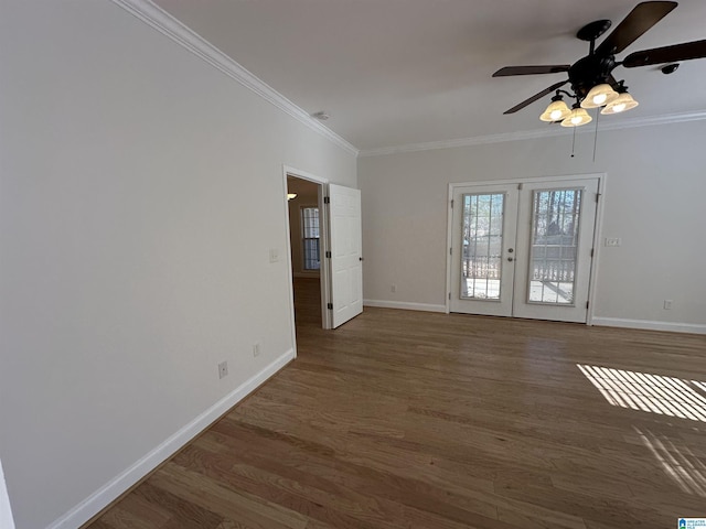 spare room featuring french doors, dark wood-type flooring, ceiling fan, and crown molding