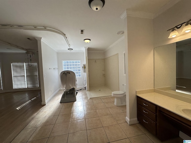 bathroom with walk in shower, tile patterned flooring, toilet, vanity, and ornamental molding