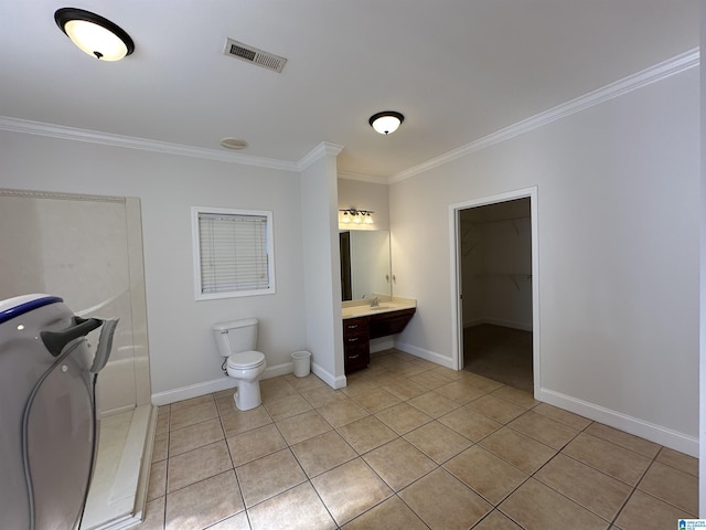 bathroom featuring tile patterned floors, vanity, toilet, and crown molding