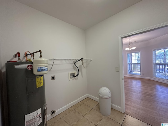 clothes washing area with electric water heater, washer hookup, hookup for an electric dryer, a notable chandelier, and light tile patterned flooring