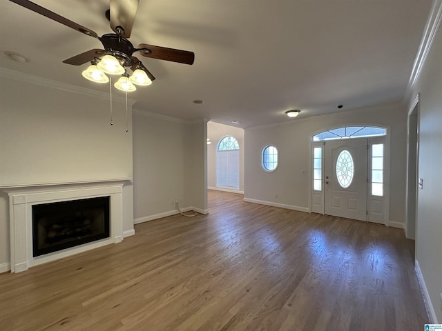 foyer featuring hardwood / wood-style floors, ceiling fan, and crown molding