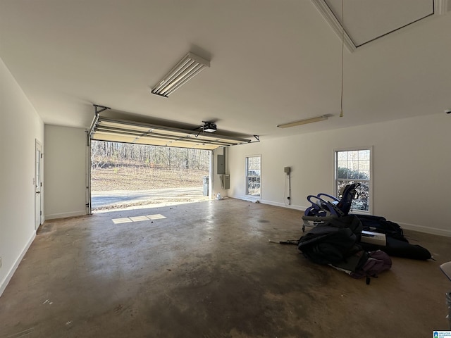 garage with electric panel and a garage door opener