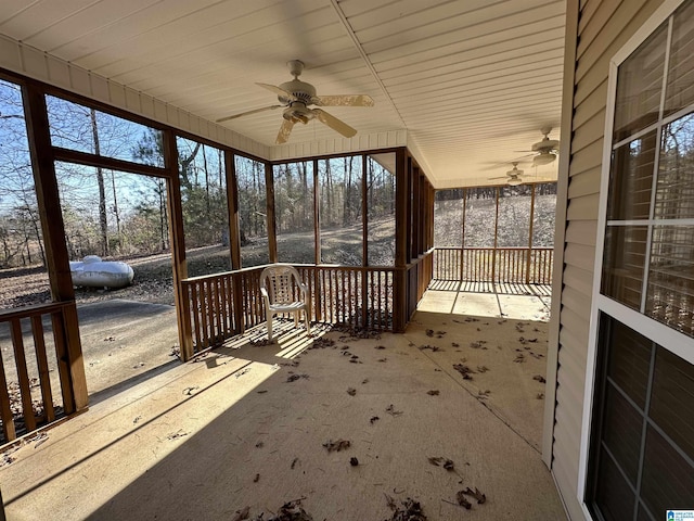 unfurnished sunroom featuring ceiling fan